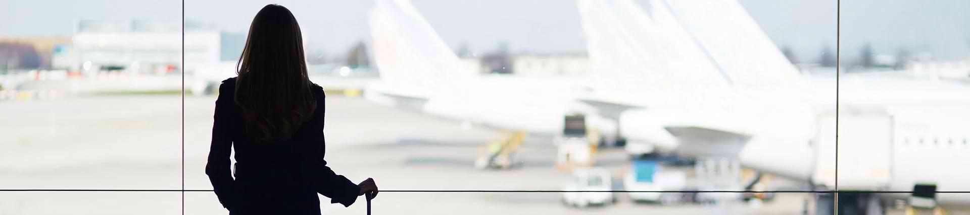 Woman in airport watching planes