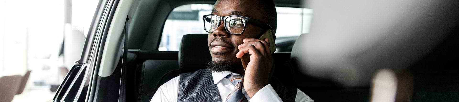 Man in a taxi with a phone