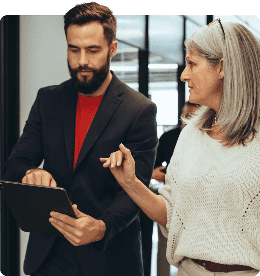 A man with a tablet is discussing with a colleague